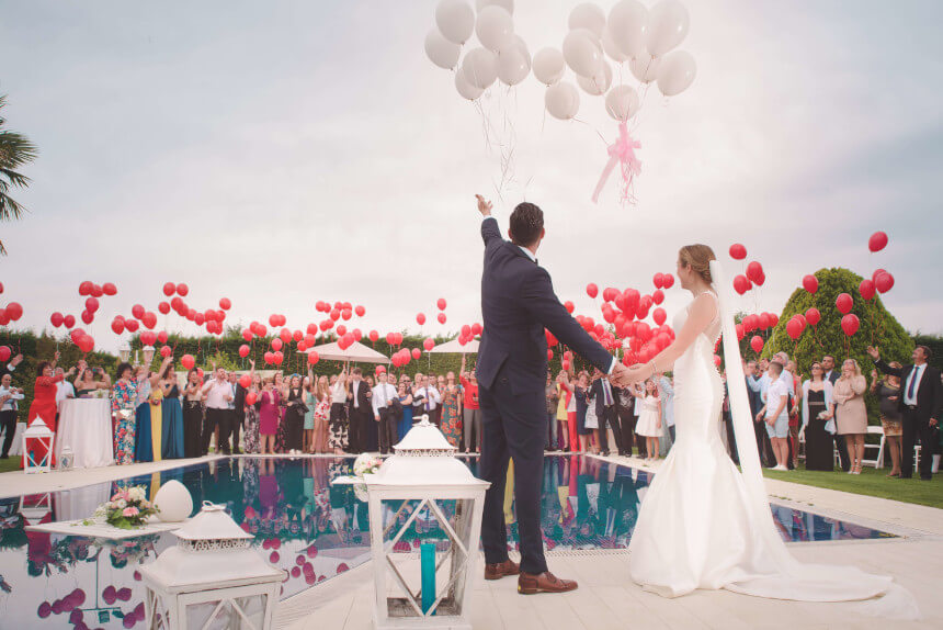 wedding in the garden all guests have red ballons